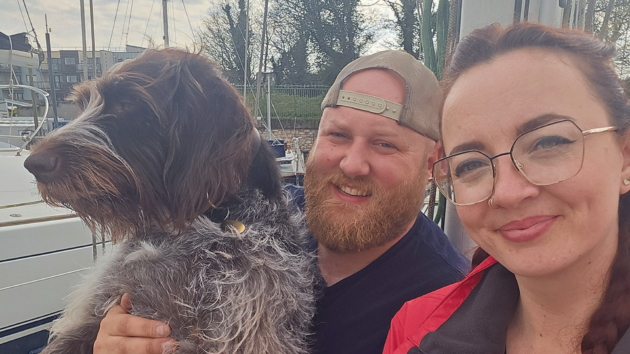 Matt and Paige livea board with their dog Lancer